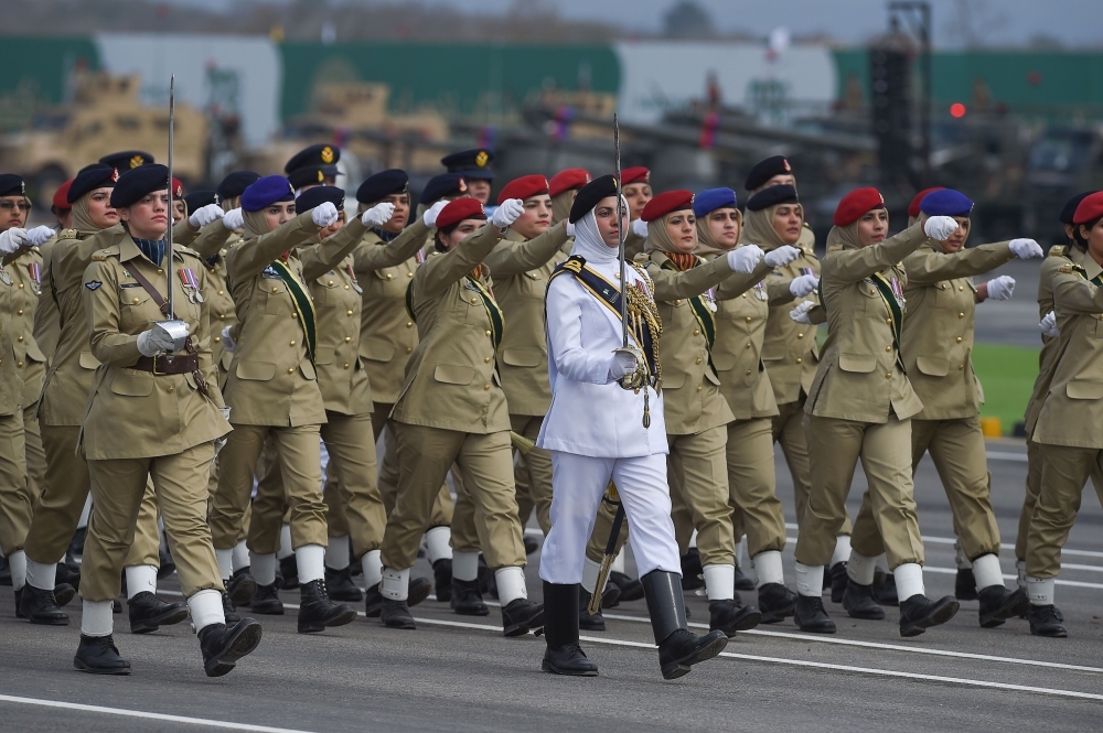 Pakistan women troops march during the Pakistan Day parade in Islamabad, Saturday. — AFP