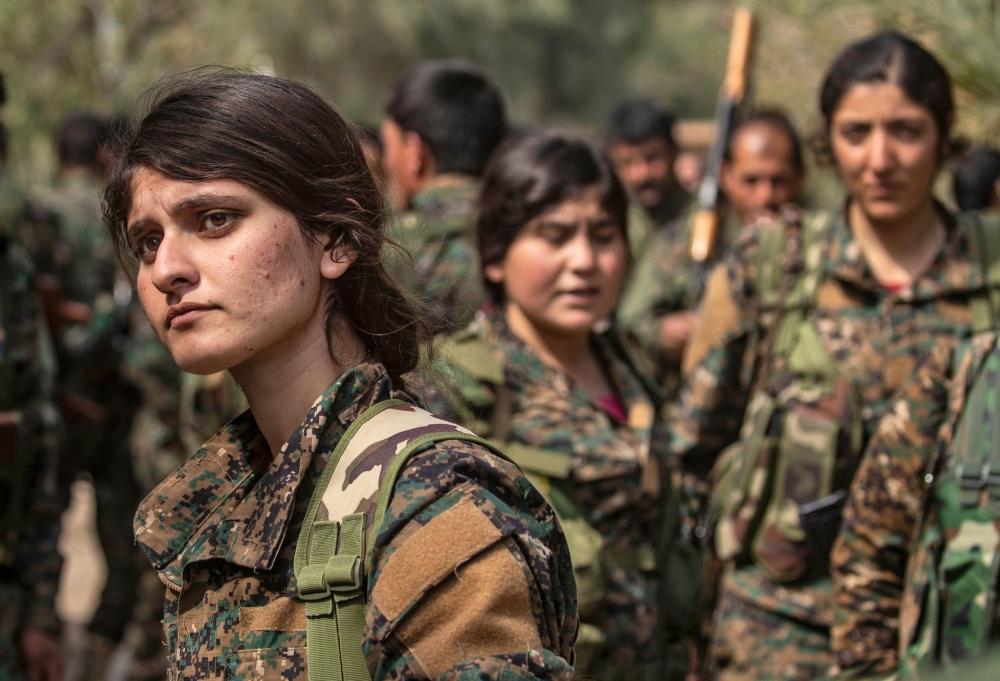 Fighters of the US-backed Kurdish-led Syrian Democratic Forces (SDF) gather to celebrate near the Omar Oil Field in the eastern Syrian Deir Ez-Zor province on Saturday, after announcing the total elimination of Daesh (the so-called IS) group's last bastion in eastern Syria. — AFP 