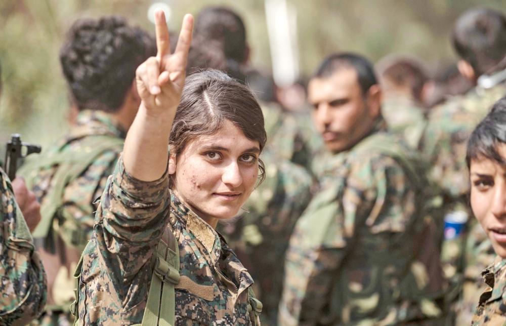 Fighters of the US-backed Kurdish-led Syrian Democratic Forces (SDF) gather to celebrate near the Omar Oil Field in the eastern Syrian Deir Ez-Zor province on Saturday, after announcing the total elimination of Daesh (the so-called IS) group's last bastion in eastern Syria. — AFP 