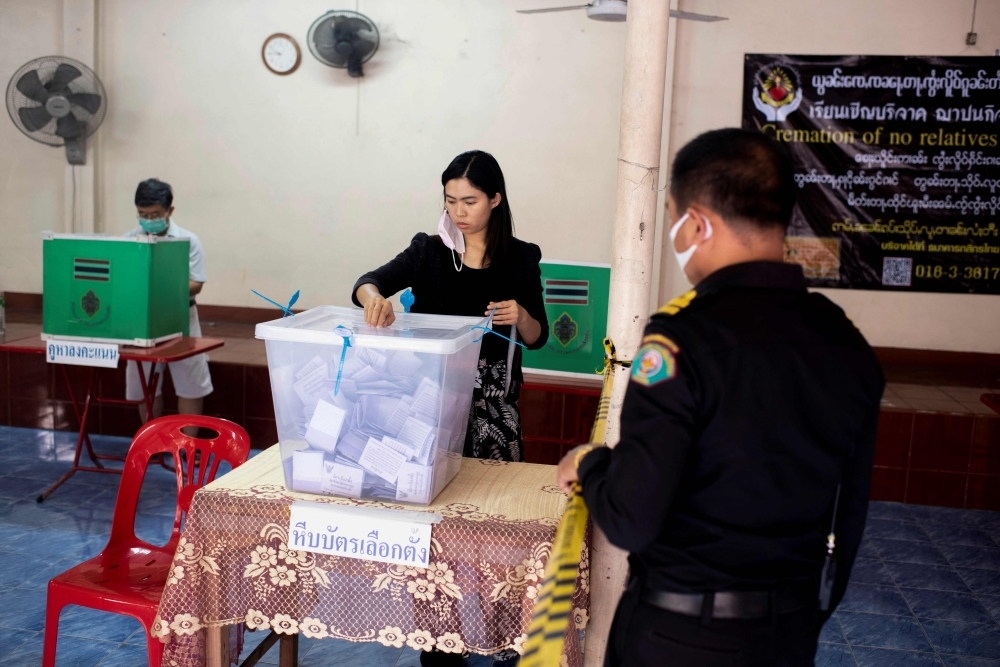 Voters cast their ballots at a polling station in Chiang Mai on Sunday during Thailand's general election. — AFP

