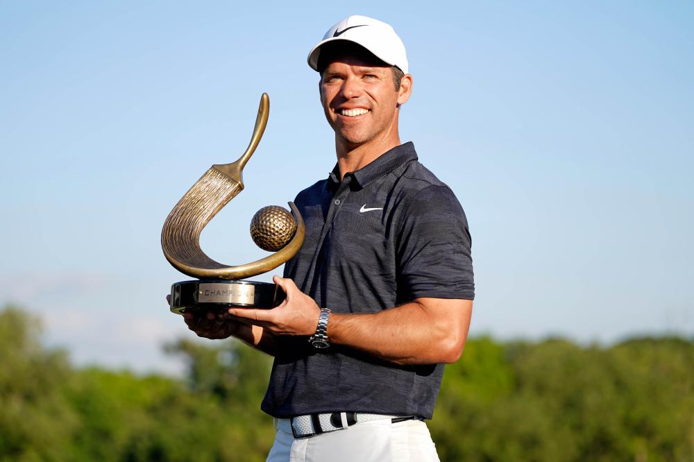 Paul Casey holds the trophy after winning the Valspar Championship Golf Tournament at Innisbrook Resort in Palm Harbor Sunday. — Reuters