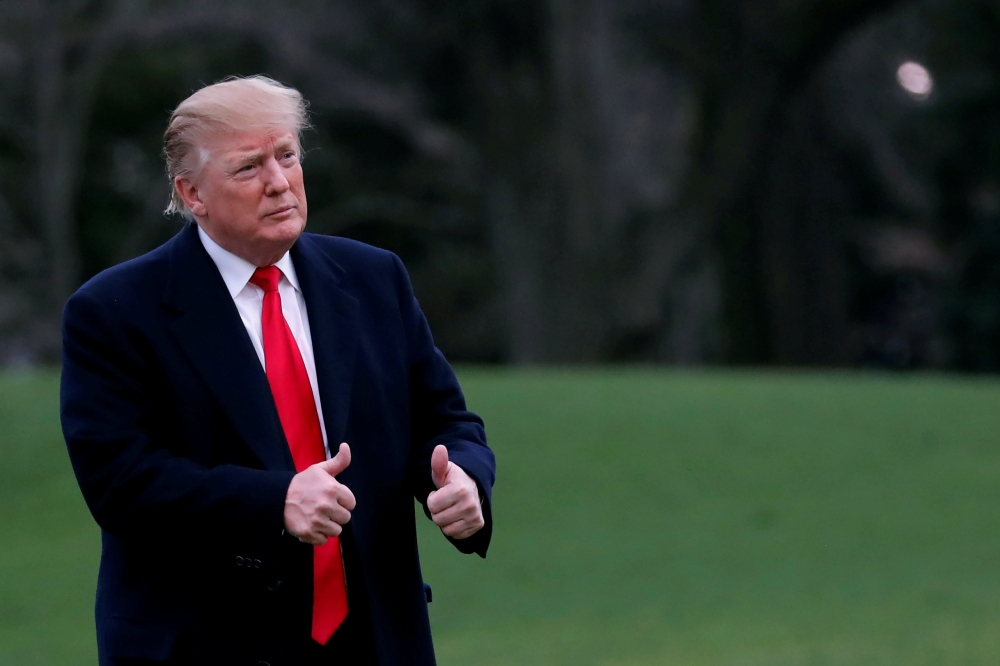 US President Donald Trump reacts as he returns to the White House after US Attorney General William Barr reported to congressional leaders on the submission of the report of Special Counsel Robert Mueller in Washington on Sunday. — Reuters