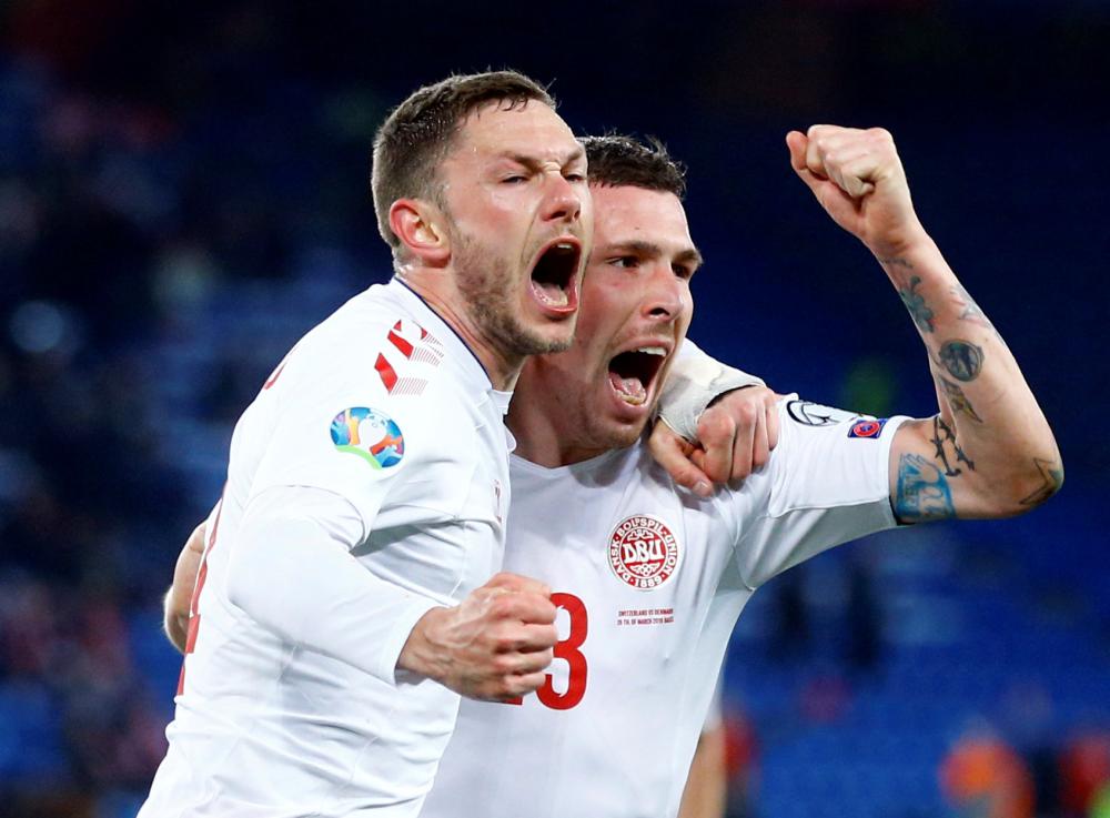 Denmark’s Henrik Dalsgaard celebrates scoring their third goal with Pierre-Emile Hojbjerg during their Euro 2020 qualifying match against Switzerland St. Jakob-Park in Basel Tuesday. — Reuters