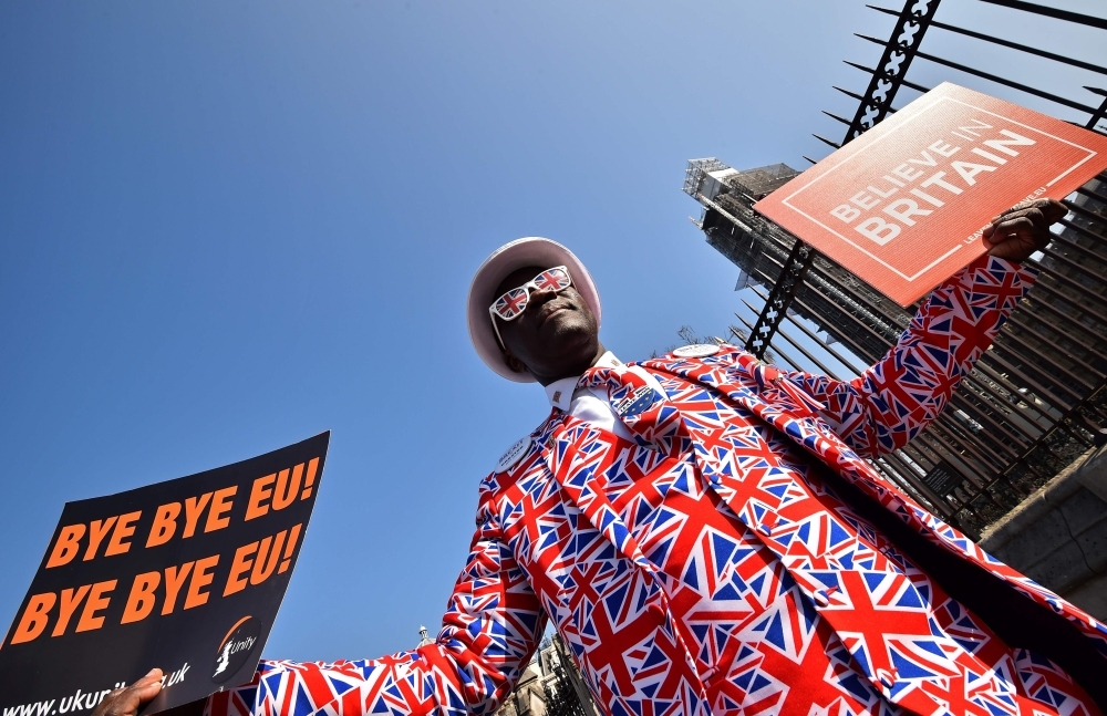 Pro-Brexit activist Joseph Afrane demonstrates outside the Houses of Parliament in London on Friday, as MPs debate the Government's Withdrawal Agreement ahead of a vote on it today. — AFP