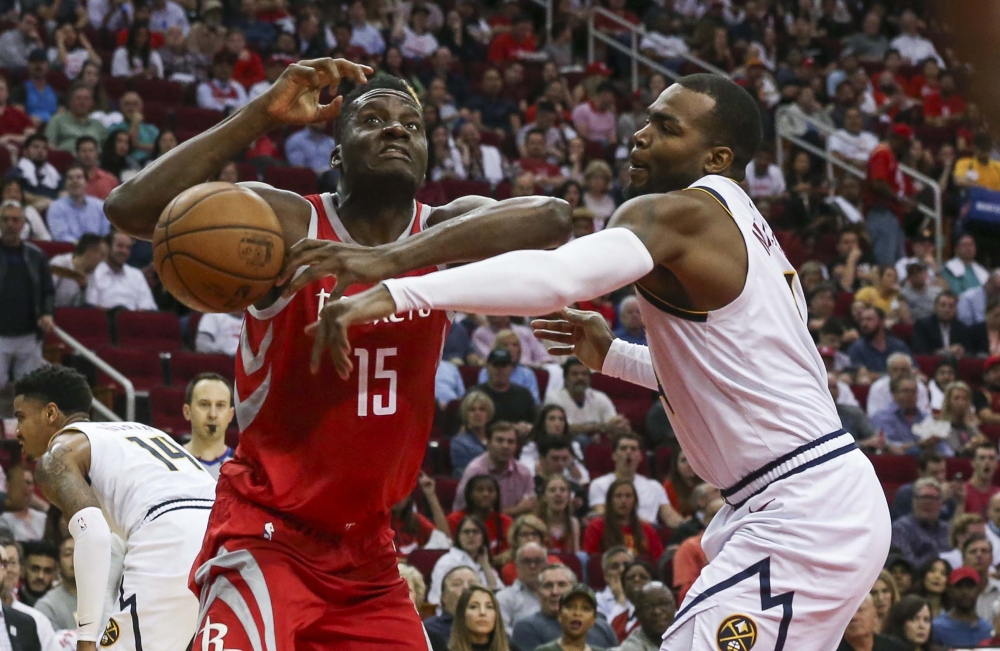 Denver Nuggets forward Paul Millsap (4) attempts to get the ball from Houston Rockets center Clint Capela (15) during the second quarter at Toyota Center. — Reuters