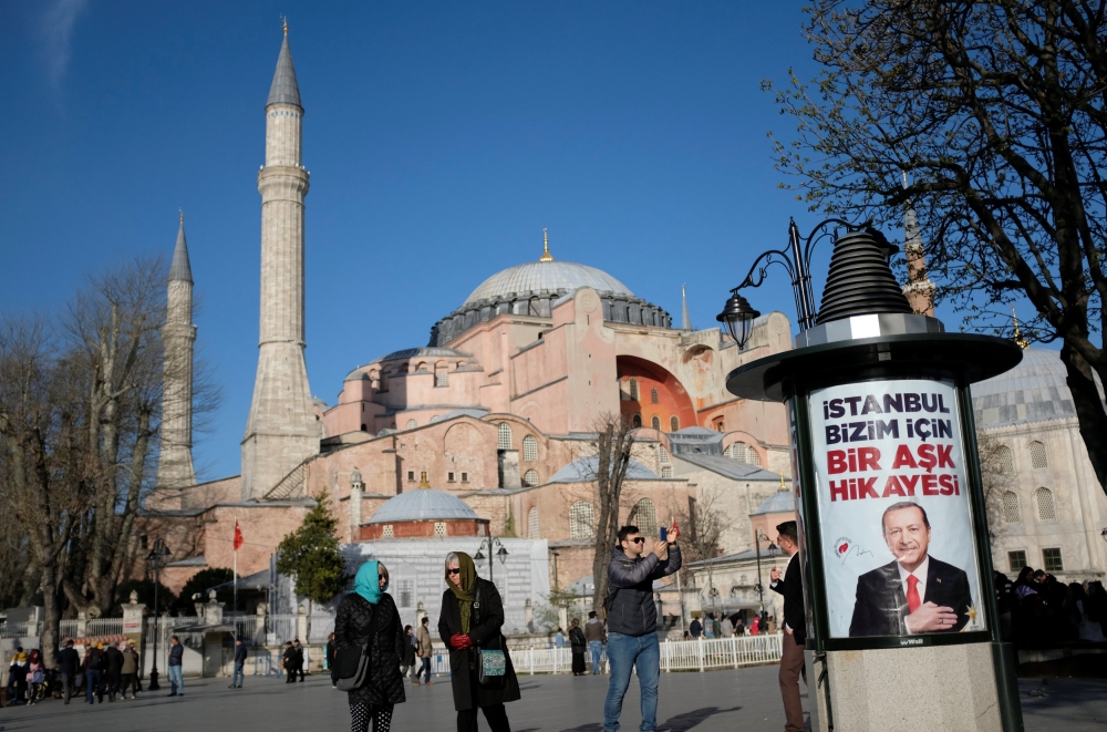 An election banner of Turkish President Tayyip Erdogan, with the Byzantine-era monument of Hagia Sophia in the background, is pictured in Istanbul, Turkey, on Thursday. — Reuters