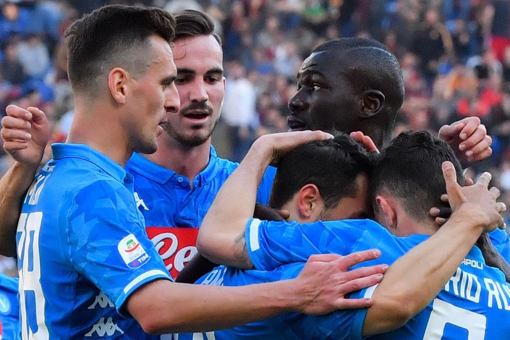 Napoli's Amin Younes (2nd R) celebrates with (from L) Arkadiusz Milik, Fabian Ruiz, Kalidou Koulibaly and Mario Rui after scoring during the Italian Serie A football match aganst Roma at the Olympic Stadium in Rome Sunday. — AFP