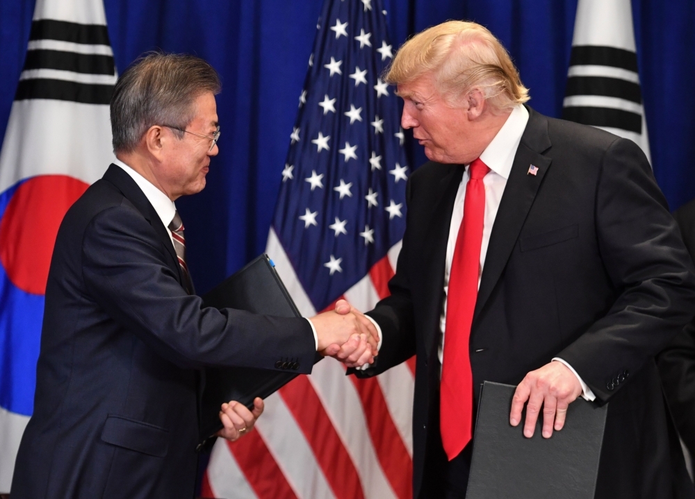 US President Donald Trump, right, and South Korean President Moon Jae-in shake hands after signing a trade agreement at a bilateral meeting in New York, a day before the start of the General Debate of the 73rd session of the General Assembly, in this Sept. 24, 2018 file photo. — AFP