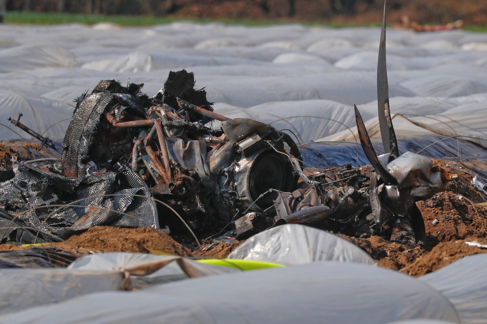 The remains of a small plane are seen on a field near Erzhausen, Germany, on Monday. 