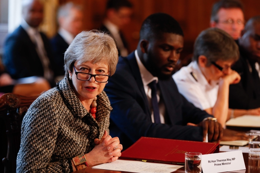 Britain’s Prime Minister Theresa May, left, hosts a Serious Youth Violence Summit next to Youth Justice Board co-chair Roy Sefa-Attakora, center, and Metropolitan Police commissioner Cressida Dick, right, at 10 Downing Street in central London on Monday. — AFP