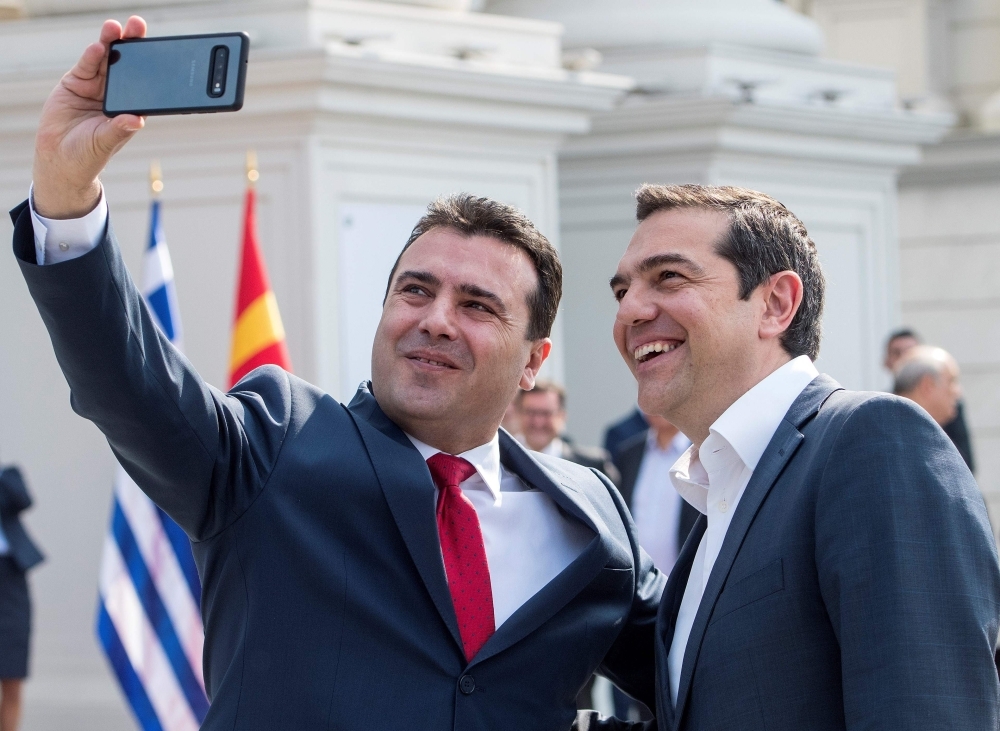 Macedonian Prime Minister Zoran Zaev, left, makes a selfie with his Greek counterpart Alexis Tsipras prior to their meeting in Skopje on Tuesday. — AFP