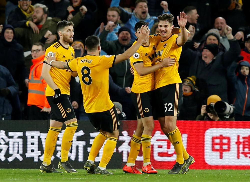 Wolverhampton Wanderers’ Leander Dendoncker (R) celebrates with teammates after Manchester United’s Chris Smalling scored an own goal during their Premier League match at Molineux Stadium, Wolverhampton, Tuesday. — Reuters