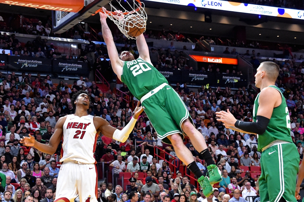 Boston Celtics forward Gordon Hayward (20) dunks the ball against Miami Heat center Hassan Whiteside (21) during the second half at American Airlines Arena.  — Reuters