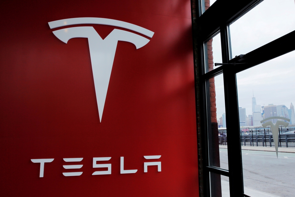 A Tesla logo is painted on a wall inside of a Tesla dealership in New York, US, in this file photo. — Reuters