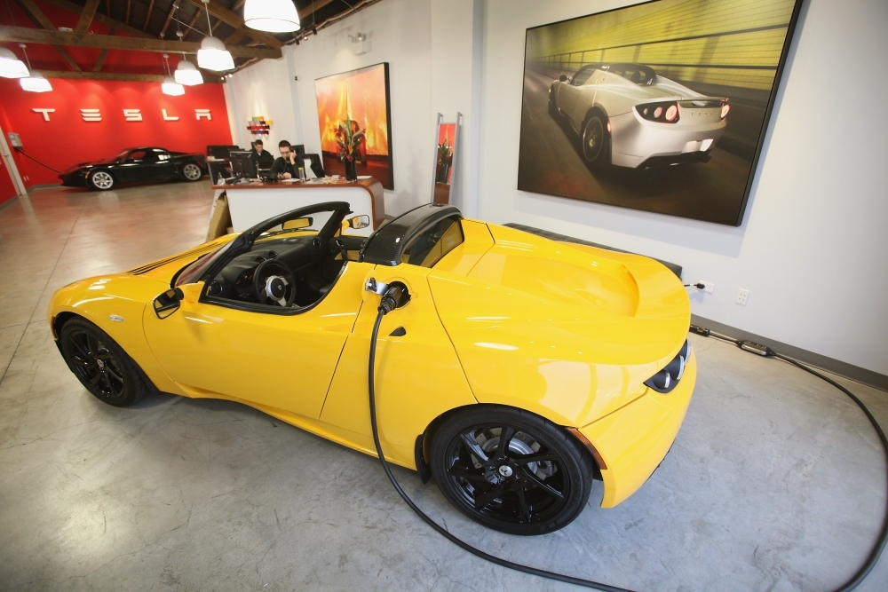 A Tesla logo is painted on a wall inside of a Tesla dealership in New York, US, in this file photo. — Reuters