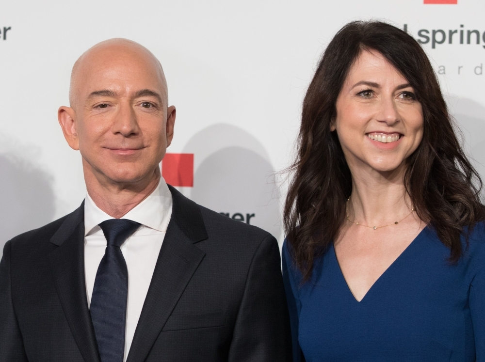 Amazon CEO Jeff Bezos and his wife MacKenzie Bezos  poses as they arrive at the headquarters of publisher Axel-Springer in Berlin in this file photo. — AFP