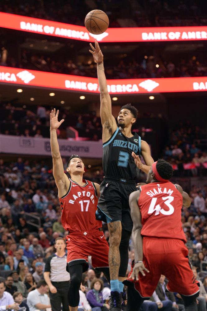 Charlotte Hornets’ guard forward Jeremy Lamb shoots as he is defended by Toronto Raptors’ guard Jeremy Lin (L) and forward Pascal Siakam during their NBA game at the Spectrum Center in Charlotte Friday. — Reuters