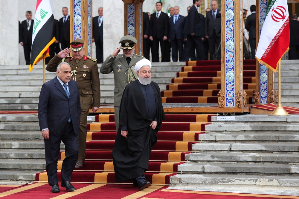 Iranian President Hassan Rohani walks with Iraq's Prime Minister Adel Abdul Mahdi during a welcome ceremony in Tehran, Saturday. — Reuters