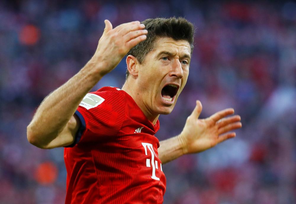 Bayern Munich’s Robert Lewandowski celebrates scoring their second goal against Borussia Dortmund during their Bundesliga match at Allianz Arena, Munich, Saturday. — Reuters