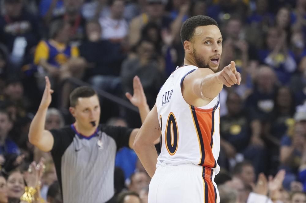 Golden State Warriors’ guard Stephen Curry celebrates after making a three-point basket against the LA Clippers during their NBA game at Oracle Arena in Oakland Sunday. — Reuters