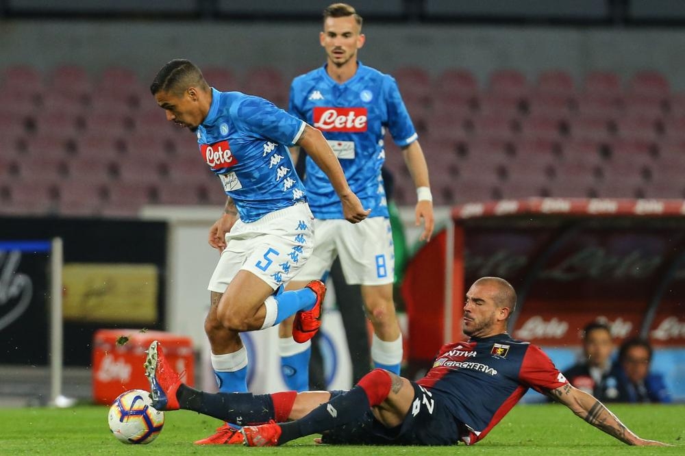 Genoa’s Stefano Sturaro (R) tackles Napoli’s midfielder Allan during their Italian Serie A match at the San Paolo Stadium in Naples Sunday. — AFP 