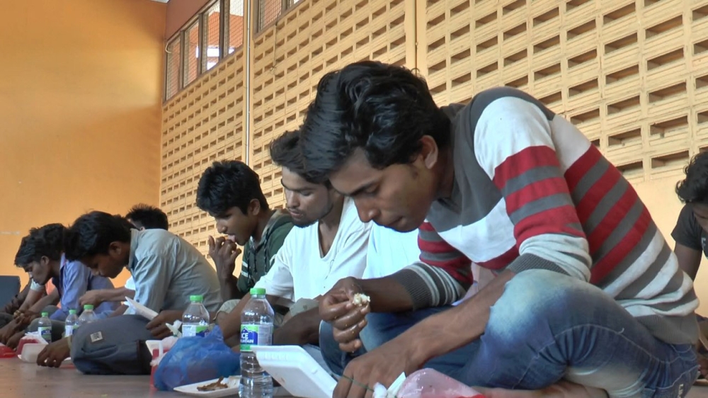 A group believed to be Rohingya Muslims from Myanmar are seen in a border security office, before being handed over to the immigration authorities, in Kuala Perlis, Malaysia, on Monday. — Reuters