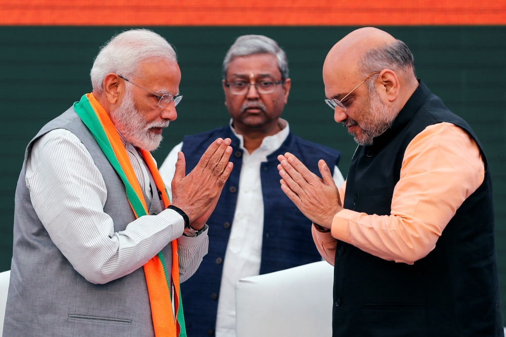 Indian Prime Minister Narendra Modi and chief of India’s ruling Bharatiya Janata Party (BJP) Amit Shah, greet each other before releasing their party’s election manifesto for the April/May general election in New Delhi, India, on Monday. — Reuters