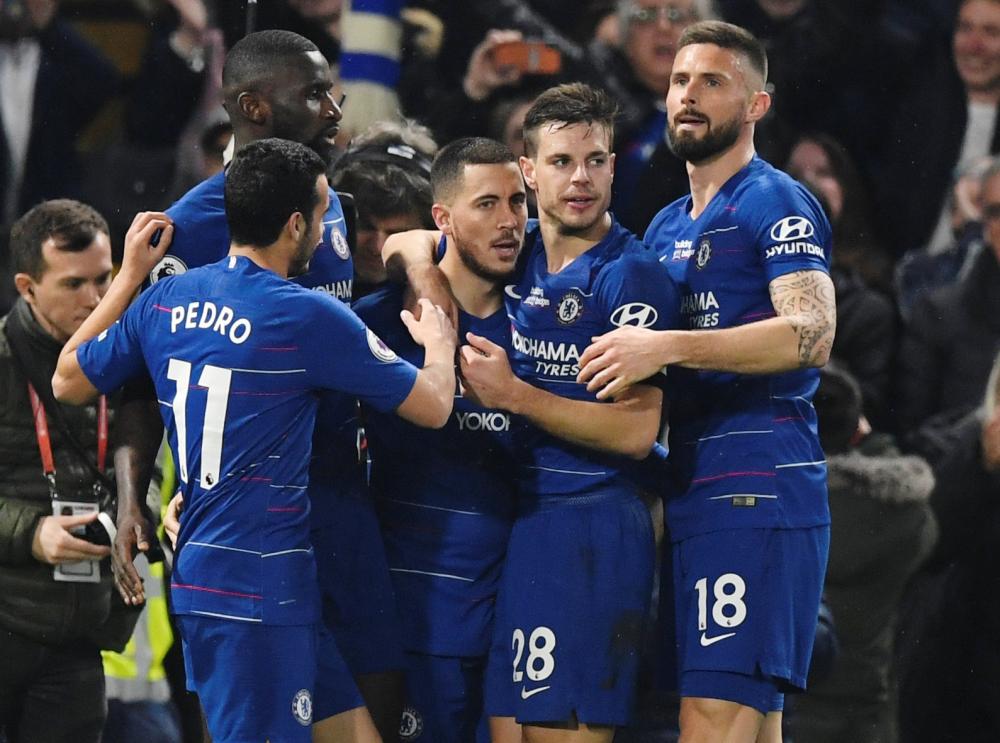 Chelsea’s Eden Hazard (3rd L) celebrates scoring their second goal with teammates during their Premier League match at Stamford Bridge, London, Monday. — Reuters