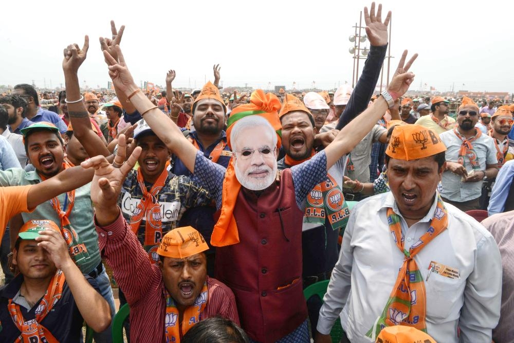 


Indian supporters of the Bharatiya Janata Party (BJP) shout slogans surrounding a man wearing a mask of Indian Prime Minister Narendra Modi at a campaign rally ahead of the national elections in Siliguri, West Bengal, in this April 3, 2019 file photo. — AFP