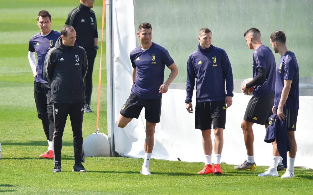 Juventus’ coach Massimiliano Allegri with Cristiano Ronaldo and teammates during training in Turin Tuesday. — Reuters