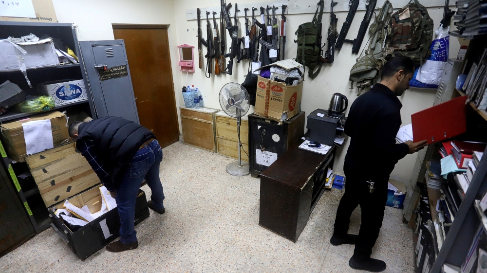 


Police officers are seen inside a room with seized drugs and weapons at a police station in Basra. — AFP photos