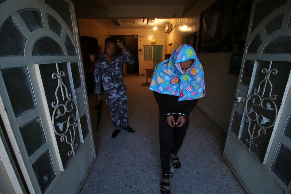 


Police officers are seen inside a room with seized drugs and weapons at a police station in Basra. — AFP photos