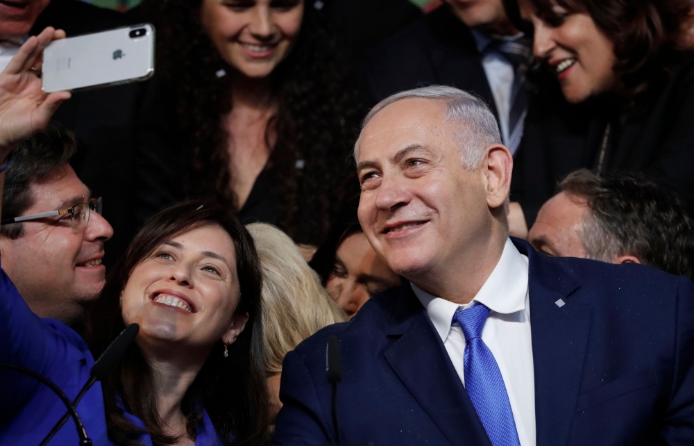 Israeli Prime Minister Benjamin Netanyahu, right, and Israeli Deputy Foreign Minister Tzipi Hotovely pose for a “selfie” photograph at his Likud Party headquarters in the Israeli coastal city of Tel Aviv on election night early on Wednesday. — AFP