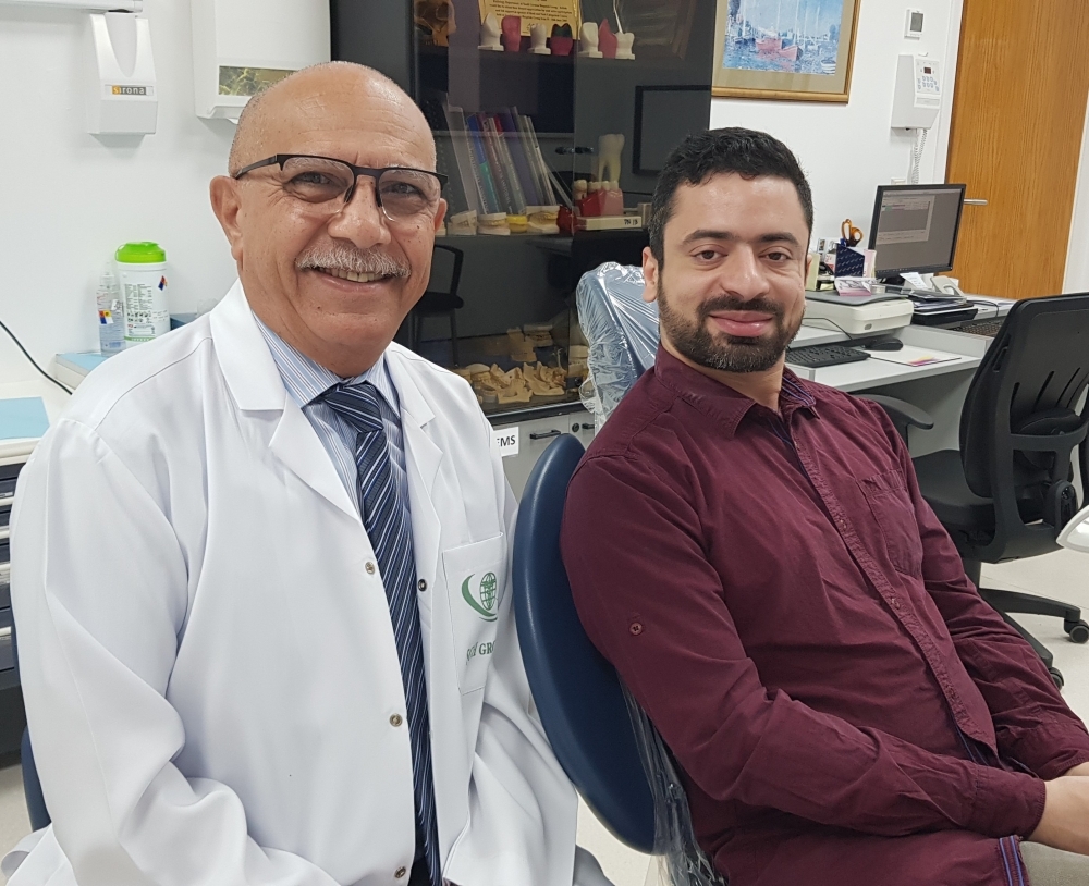


Prof. Ibrahim Hashish with his patient, who has more or less returned to normal life after the deadly accident that severely damaged his face.