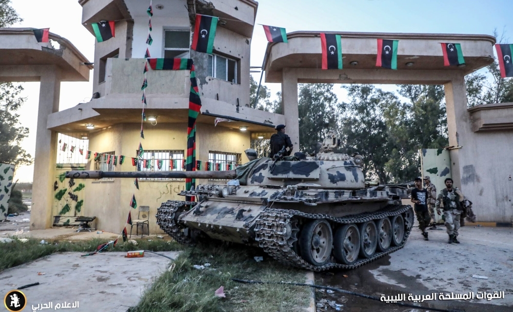 This image obtained from the Libyan strongman Khalifa Haftar's self-proclaimed Libyan National Army (LNA) War Information Division's Facebook page and released on Wednesday reportedly shows a tank and members of the LNA outside the 4th Brigade camp in Al-Aziziyah, located some 40 km south of the Libyan capital Tripoli. — AFP