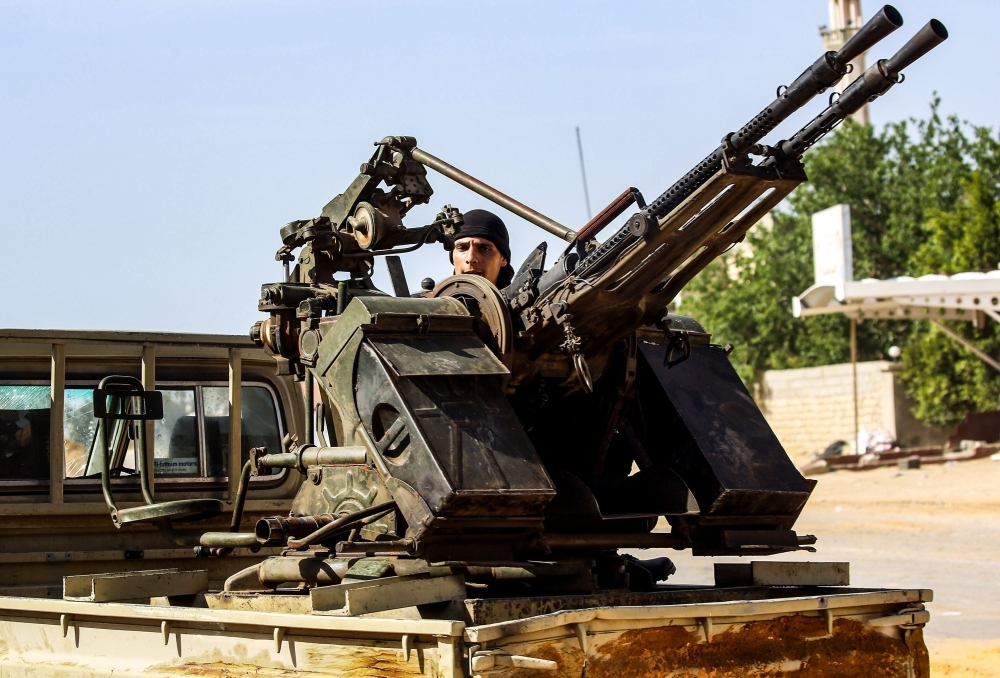 A Libyan fighter loyal to the Government of National Accord (GNA) mans a turret mounted on the back of a pickup truck during clashes with forces loyal to strongman Khalifa Haftar south of the capital Tripoli’s suburb of Ain Zara on Wednesday. — AFP