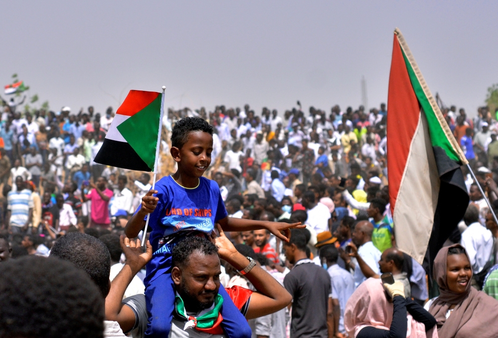 Sudanese demonstrators chant slogans along the streets after Sudan’s Defense Minister Awad Mohamed Ahmed Ibn Auf said that President Omar Bashir had been detained “in a safe place” and that a military council would run the country for a two-year transitional period in Khartoum, Sudan, on Thursday. — Reuters