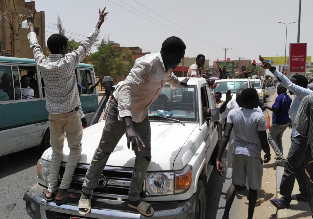 Sudanese demonstrators chant slogans along the streets after Sudan’s Defense Minister Awad Mohamed Ahmed Ibn Auf said that President Omar Bashir had been detained “in a safe place” and that a military council would run the country for a two-year transitional period in Khartoum, Sudan, on Thursday. — Reuters
