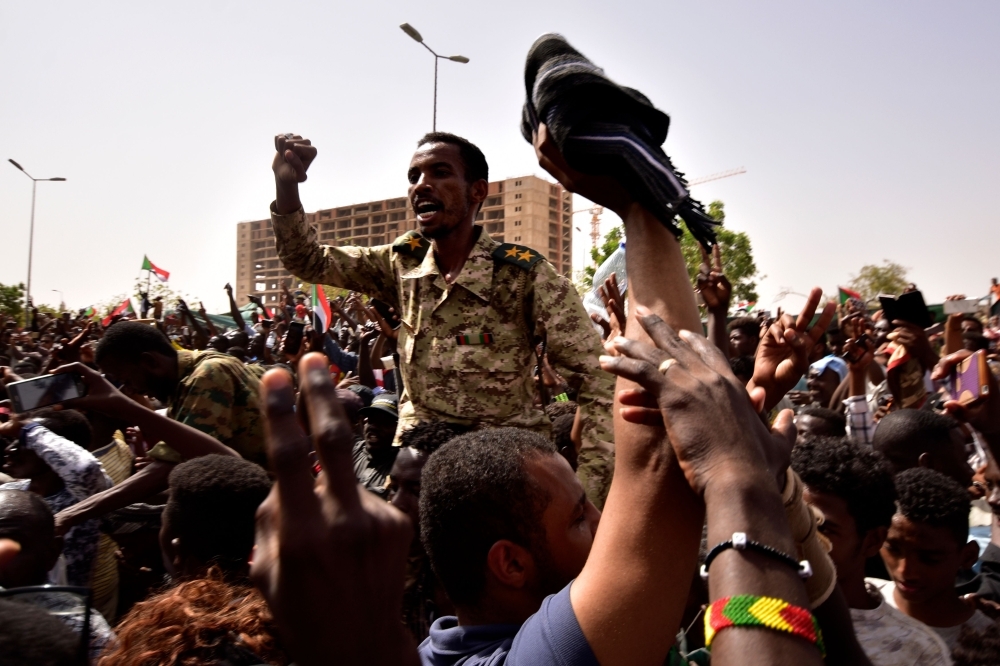 Sudanese demonstrators gather in a street in central Khartoum on Thursday. — AFP