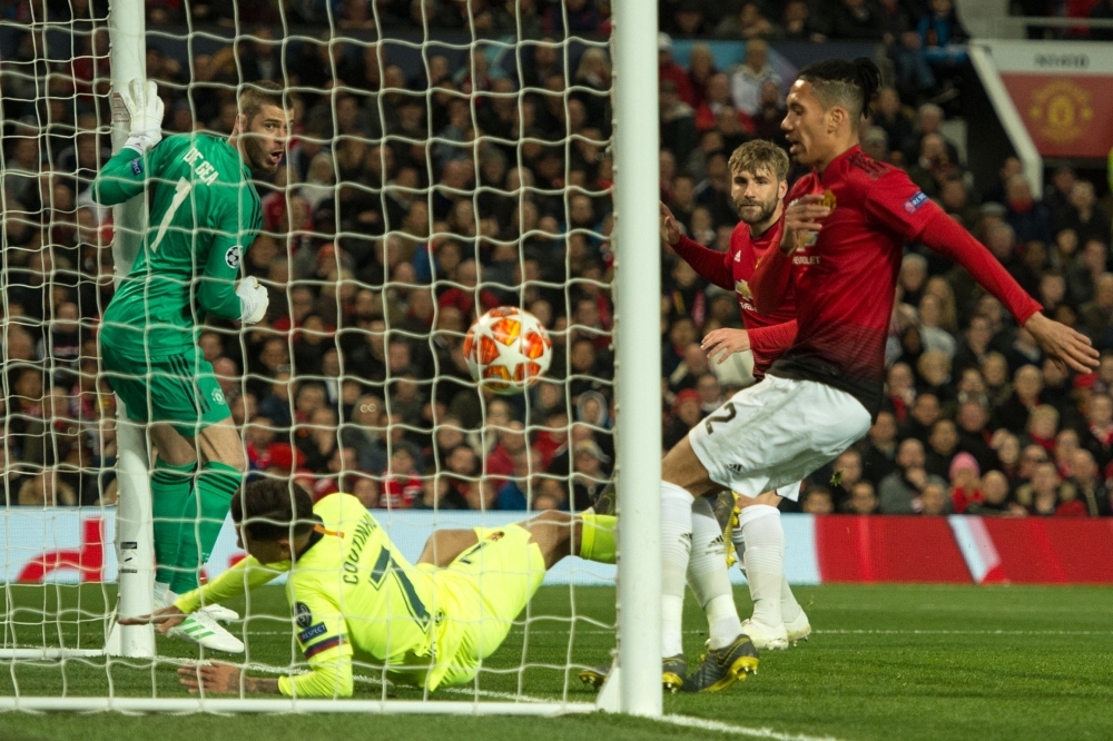 Manchester United's Spanish goalkeeper David de Gea (L) looks on as a shot from Barcelona's Uruguayan forward Luis Suarez strikes Manchester United's English defender Luke Shaw (2R) and is awarded as an own goal during the UEFA Champions league first leg quarterfinal football match at Old Trafford in Manchester, north west England, on Wednesday. — AFP