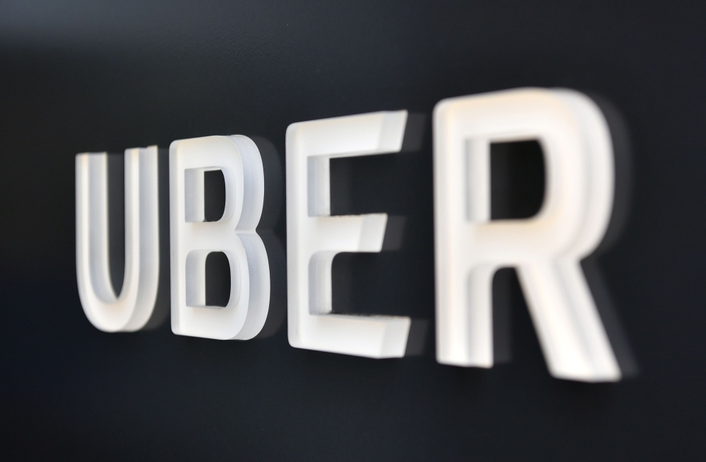 In this file photo the Uber logo is seen outside the Uber Corporate Headquarters building in San Francisco, California. Uber filed documents Thursday for its much-anticipated public share offering expected to be the largest in the tech sector in years and a bellwether for other venture-backed startups eyeing Wall Street listing.— AFP