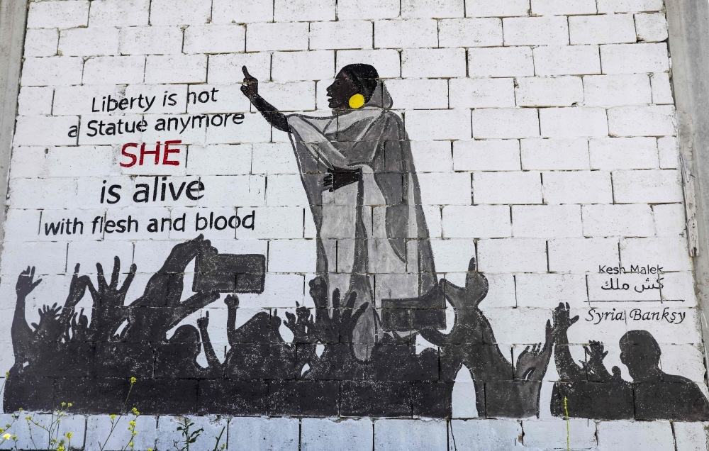 This picture taken on Friday shows a view of a mural painting of Alaa Salah, a Sudanese woman propelled to internet fame after clips went viral of her leading powerful protest chants against President Omar Bashir, painted by a Syrian artists collective called “Kesh Malek” (Checkmate) on the wall of a farmhouse building in the rebel-held Syrian town of Kafranbel in the northwestern Idlib province. — AFP