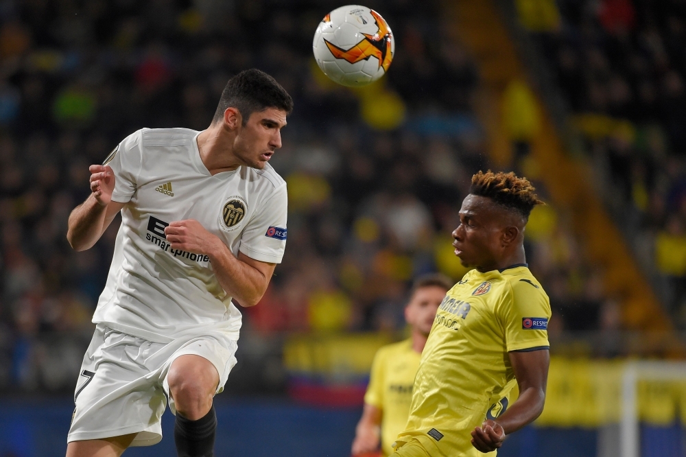 Valencia's Portuguese midfielder Goncalo Guedes (L) vies with Villarreal's Nigerian Forward Samuel Chukwueze during the UEFA Europa league quarterfinal first leg football match at La Ceramica stadium in Villareal on Thursday. — AFP