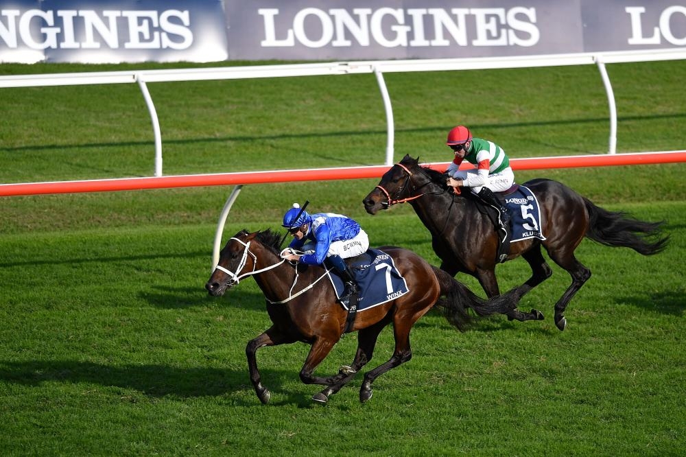 Jockey Hugh Bowman (L) rides on the back of champion race horse Winx in the seventh race at the Longines Queen Elizabeth Stakes during the Championships Race Day in Sydney Saturday. Champion Australian mare Winx bid farewell by winning her 33rd race in a row, ending her glittering career on a high with an amazing four-year unbeaten streak. — AFP 