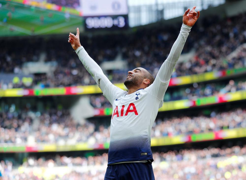 Tottenham’s Lucas Moura celebrates after completing a hat trick against Huddersfield during their Premier League match at Tottenham Hotspur Stadium in London Saturday. — Reuters