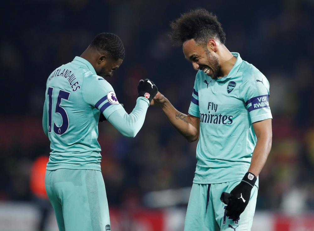 Arsenal’s Pierre-Emerick Aubameyang (R) and Ainsley Maitland-Niles celebrate after their Premier League match against Watford at Vicarage Road, Watford, Monday. — Reuters