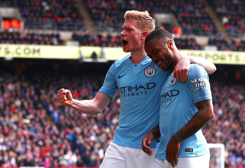 Kevin De Bruyne (L) celebrates Raheem Sterling’s goal for Manchester City against Crystal Palace at Selhurst Park, London, Sunday. — Reuters