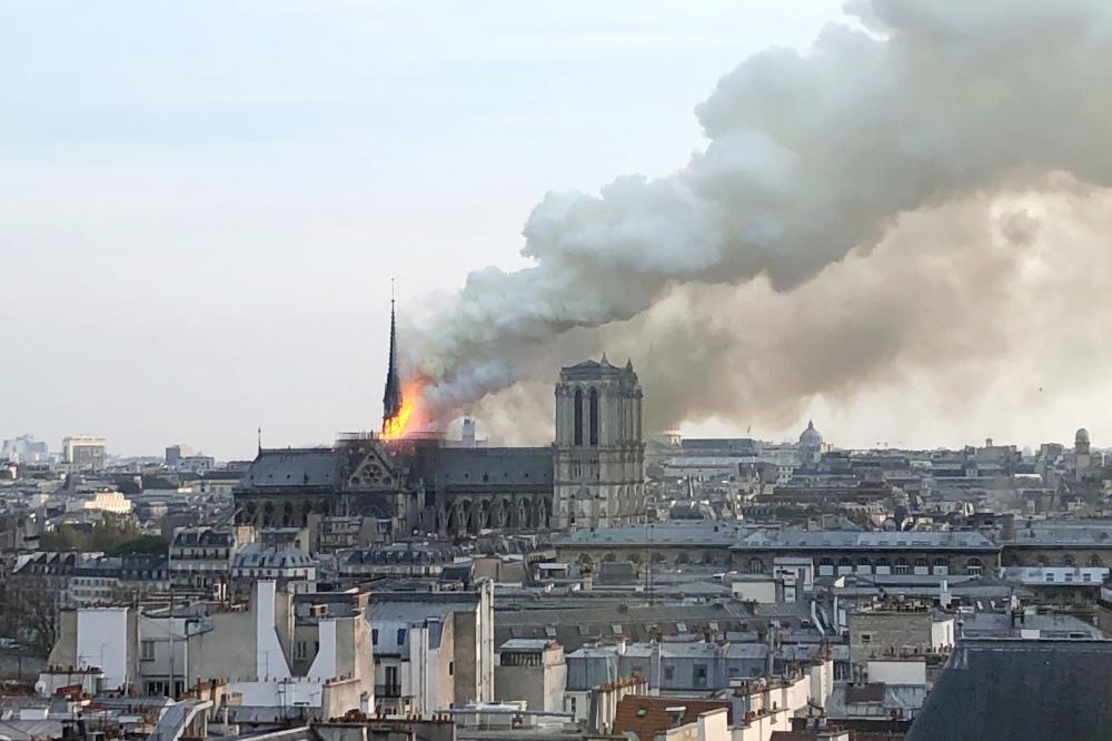 


 Flames and smoke billow from the roof at Notre-Dame Cathedral in Paris on Monday. — AFP