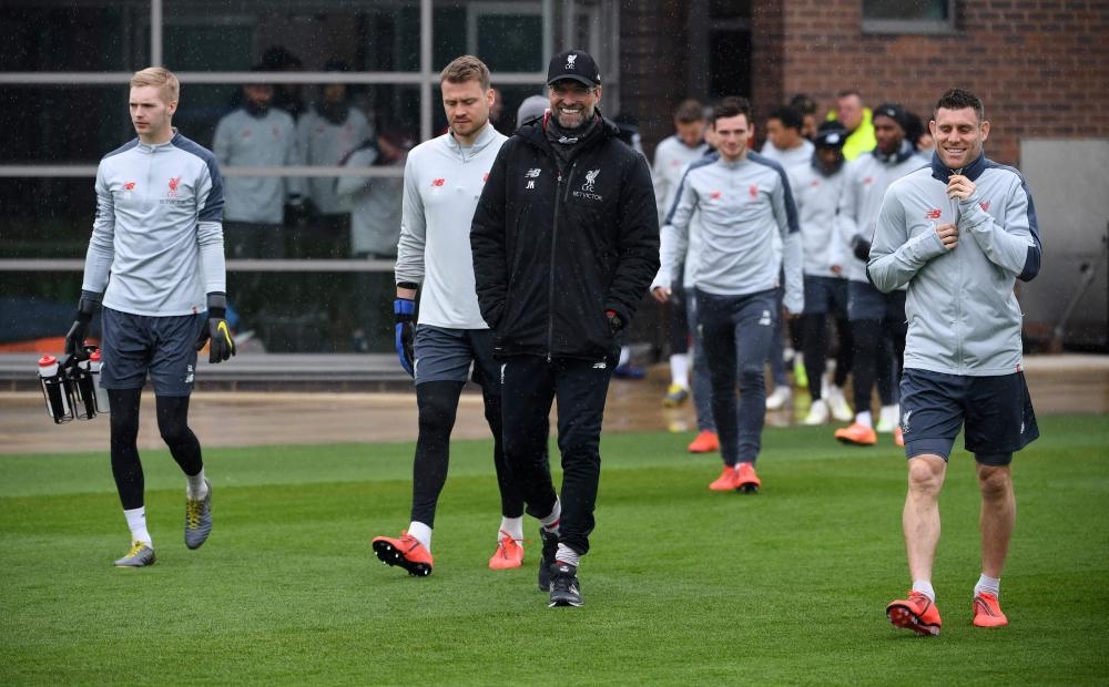 Liverpool’s manager Jurgen Klopp (C) arrives with his players to take part in a team training session at Melwood in Liverpool Tuesday. — AFP 