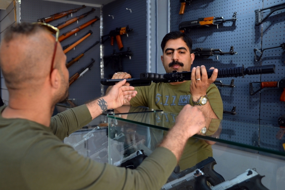 A man inspects a machine gun at a gun shop in the Iraqi Shiite holy city of Najaf in this April 15, 2019 file photo. — AFP
